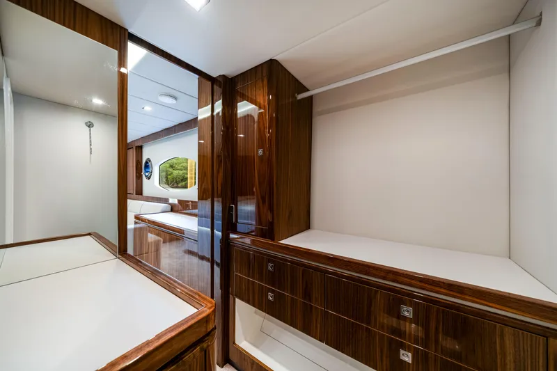  Yacht Photos Pics Luxurious interior of 2026 Riviera 6000 Sport Yacht with elegant wood finishes.