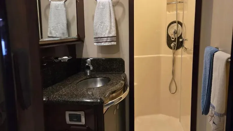  Yacht Photos Pics Luxurious bathroom in 2007 Sea Ray 580 Sedan Bridge yacht with granite countertop and shower.