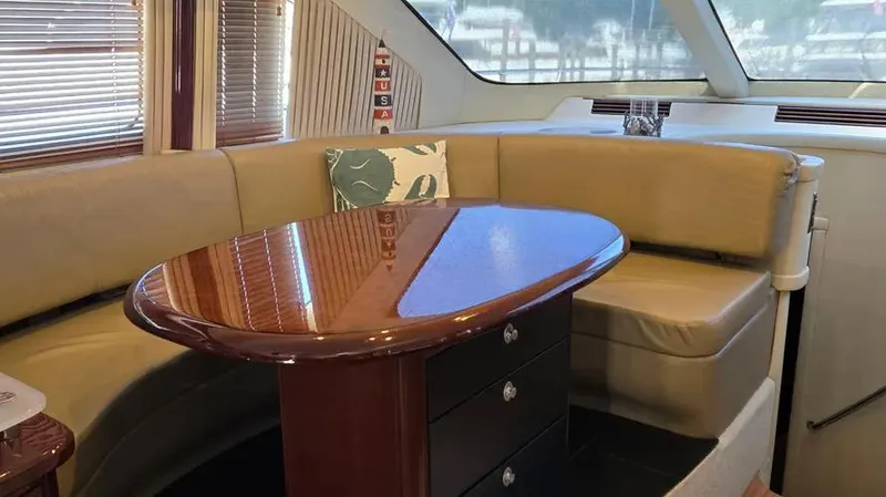  Yacht Photos Pics Luxurious 2007 Sea Ray 580 Sedan Bridge interior with elegant seating and polished wood table.