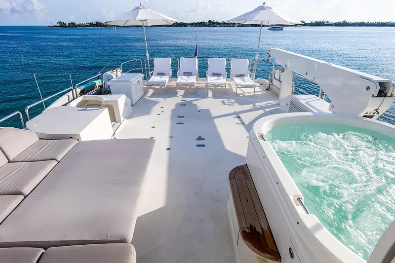 Kemosabe Yacht Photos Pics Luxurious 2007 Westport 112 yacht deck with jacuzzi, sun loungers, and ocean view.