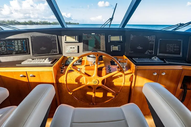 Kemosabe Yacht Photos Pics Pilothouse of 2007 Westport 112 yacht with wooden steering wheel and navigation screens.