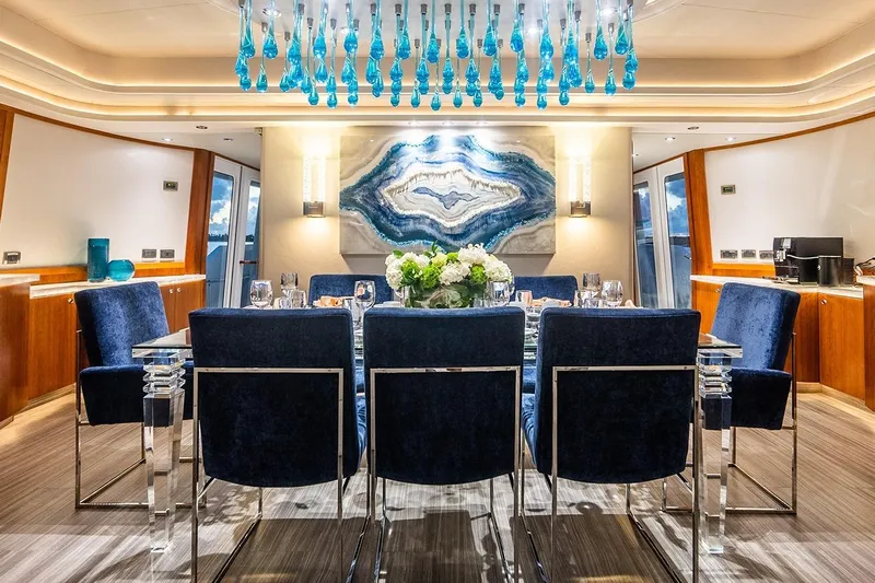 Kemosabe Yacht Photos Pics Luxurious dining area on 2007 Westport 112 yacht with elegant decor and blue accents.