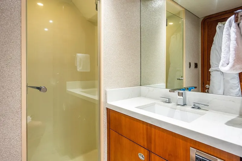 Kemosabe Yacht Photos Pics Luxurious bathroom on 2007 Westport 112 yacht with modern sink and glass shower.