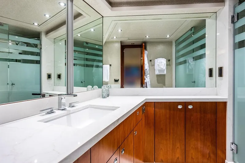 Kemosabe Yacht Photos Pics Luxurious bathroom in 2007 Westport 112 yacht with modern fixtures and wooden cabinetry.