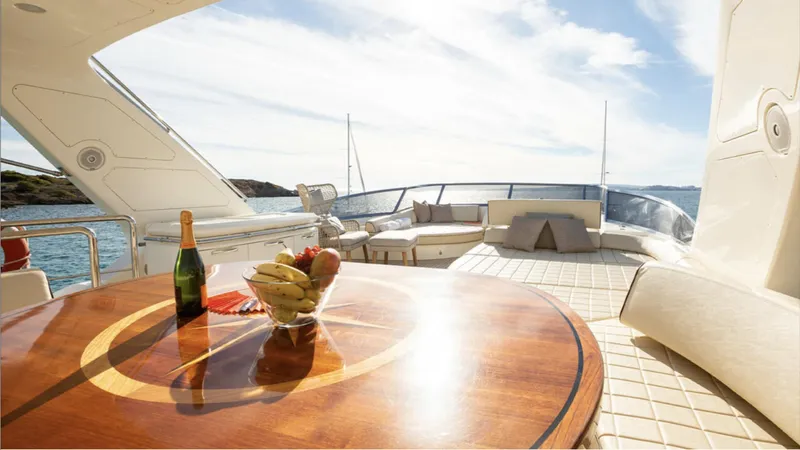  Yacht Photos Pics Luxurious 2008 Azimut 75 yacht deck with table, fruit, and champagne, overlooking serene ocean view.