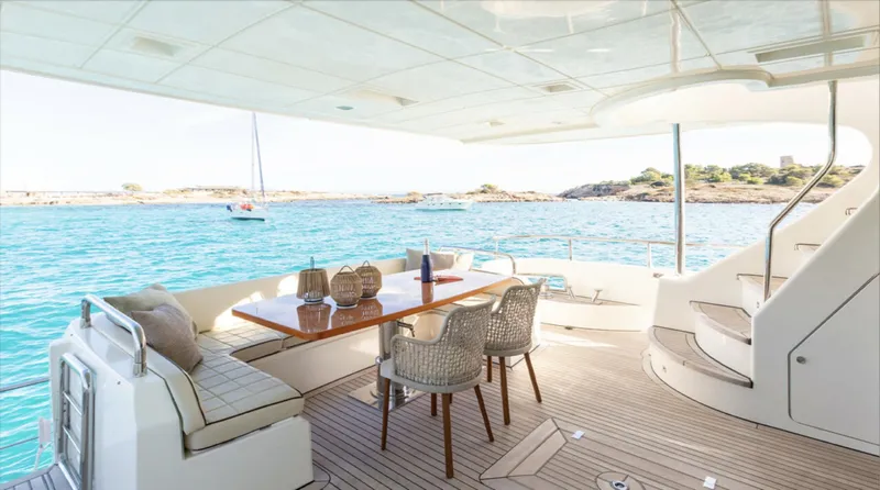  Yacht Photos Pics Luxurious 2008 Azimut 75 yacht deck with dining area, overlooking serene blue waters.