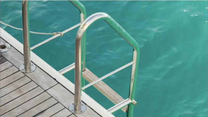  Yacht Photos Pics Stainless steel boat ladder on Azimut 75 yacht, 2008, over turquoise water.