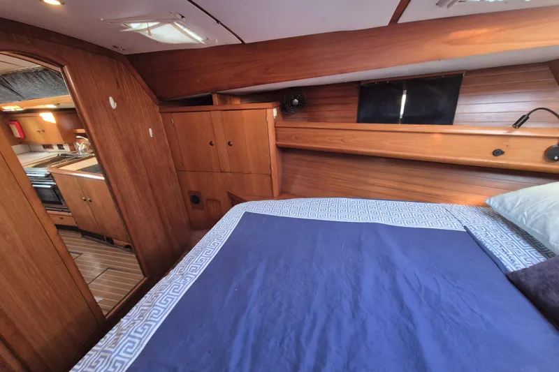Time Warp Yacht Photos Pics Cozy cabin interior of 2000 Jeanneau Sun Odyssey 45.2 sailboat with wooden finish.