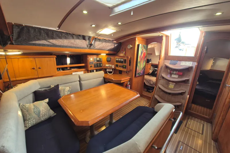 Time Warp Yacht Photos Pics Interior of 2000 Jeanneau Sun Odyssey 45.2 yacht with cozy seating and wooden finishes.