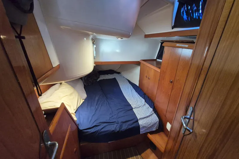 Time Warp Yacht Photos Pics Cozy cabin interior of 2000 Jeanneau Sun Odyssey 45.2 sailboat with wooden furnishings.