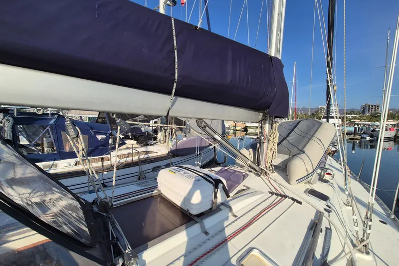 Time Warp Yacht Photos Pics Jeanneau Sun Odyssey 45.2 sailboat deck, 2000 model, docked in a marina under clear skies.