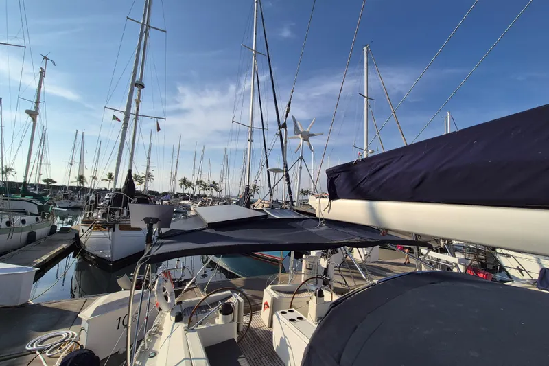 Time Warp Yacht Photos Pics Jeanneau Sun Odyssey 45.2 sailboat docked in a marina, clear blue sky.