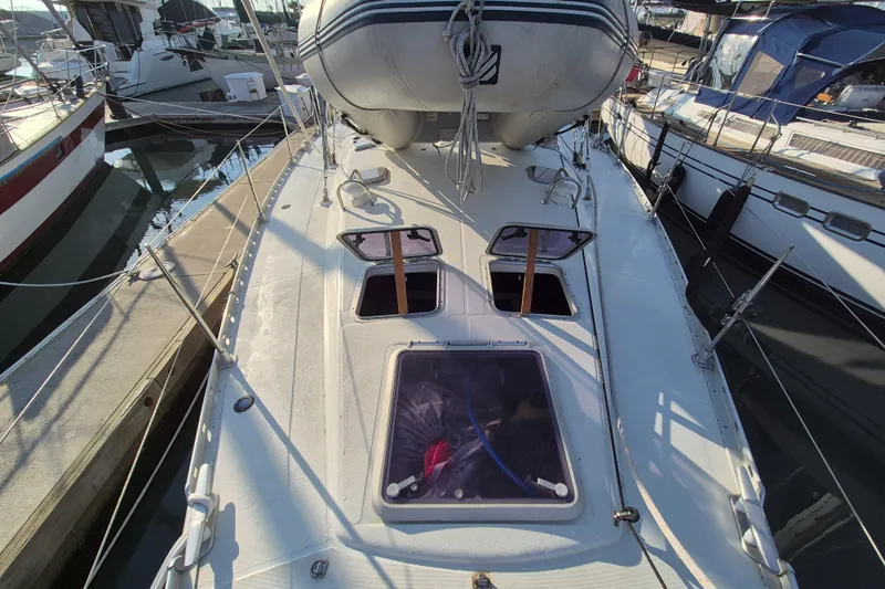 Time Warp Yacht Photos Pics Jeanneau Sun Odyssey 45.2 sailboat deck with open hatches, docked at marina, 2000 model.