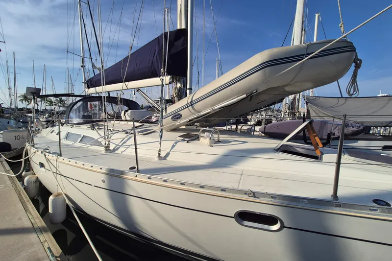 Time Warp Yacht Photos Pics 2000 Jeanneau Sun Odyssey 45.2 sailboat docked at marina under clear blue sky.
