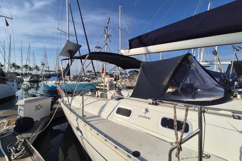 Time Warp Yacht Photos Pics Jeanneau Sun Odyssey 45.2 sailboat docked in marina, 2000 model, sunny day.