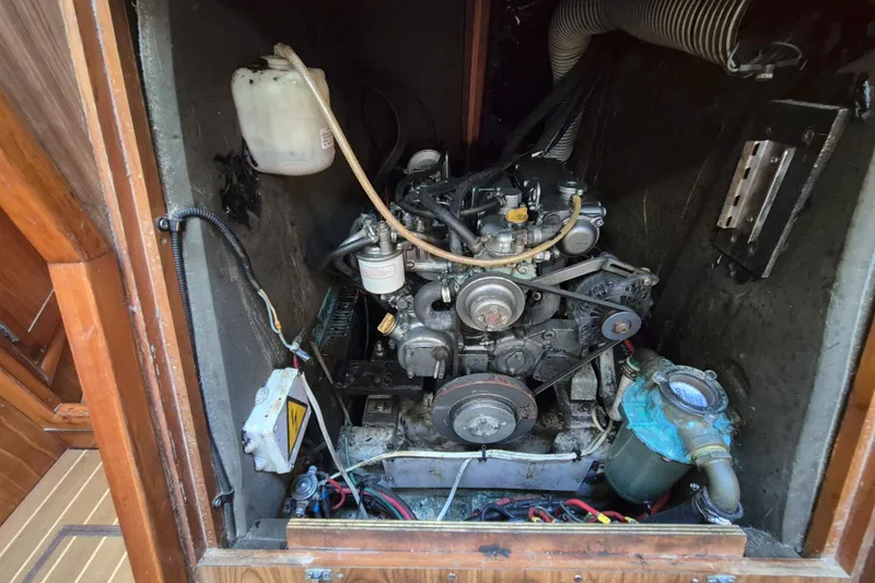Time Warp Yacht Photos Pics Engine compartment of a 2000 Jeanneau Sun Odyssey 45.2 sailboat, showing mechanical components.