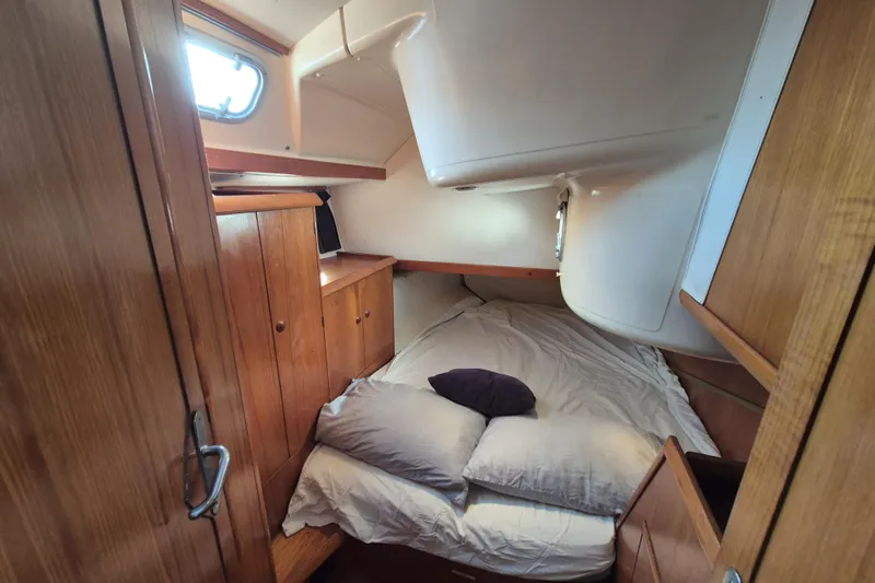Time Warp Yacht Photos Pics Cozy cabin interior of 2000 Jeanneau Sun Odyssey 45.2 sailboat with wooden furnishings.