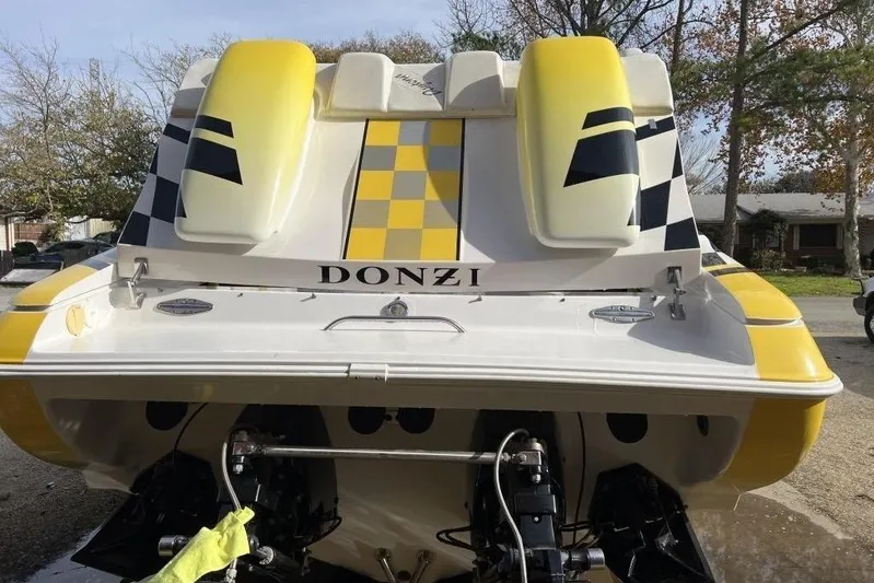  Yacht Photos Pics 2002 Donzi 38 Daytona boat with yellow and black checkered design, rear view.