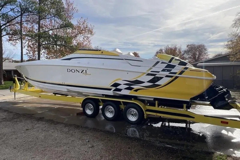  Yacht Photos Pics 2002 Donzi 38 Daytona powerboat on a yellow trailer, parked outdoors.