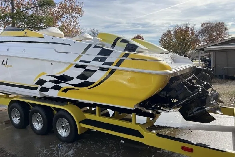  Yacht Photos Pics 2002 Donzi 38 Daytona speedboat on trailer, featuring yellow and black racing stripes.