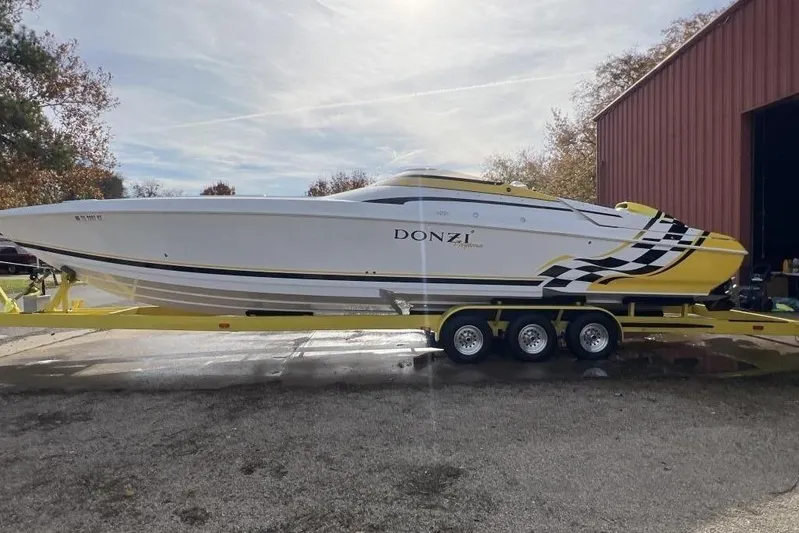  Yacht Photos Pics 2002 Donzi 38 Daytona speedboat on trailer, white with yellow and black accents.