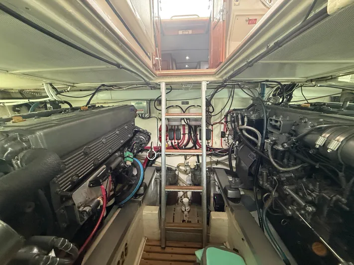 Unconquered Yacht Photos Pics Engine room of 2002 Grand Banks 43 Eastbay HX, showcasing dual engines and mechanical systems.