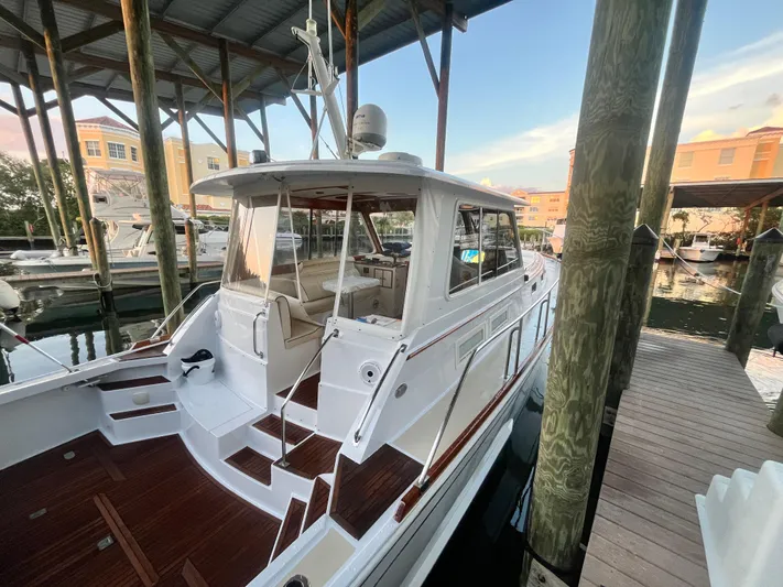 Unconquered Yacht Photos Pics 2002 Grand Banks 43 Eastbay HX docked in a marina under a covered structure.