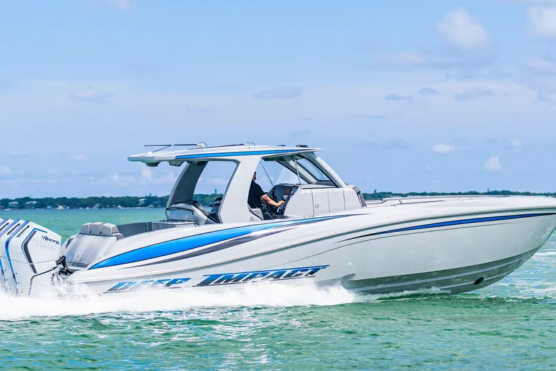  Yacht Photos Pics 2023 Deep Impact 399 Sport boat cruising on clear blue water.