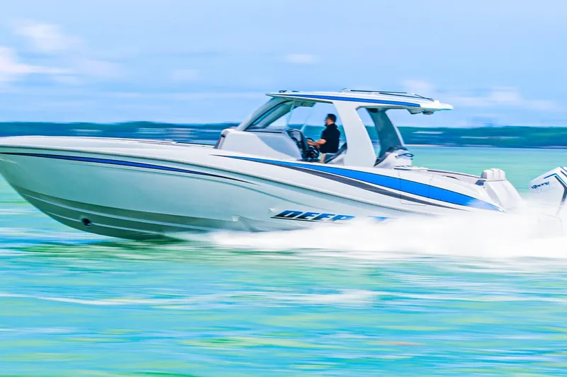  Yacht Photos Pics 2023 Deep Impact 399 Sport boat speeding on turquoise water.