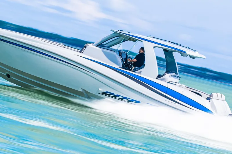  Yacht Photos Pics 2023 Deep Impact 399 Sport boat speeding on water, showcasing sleek design and performance.
