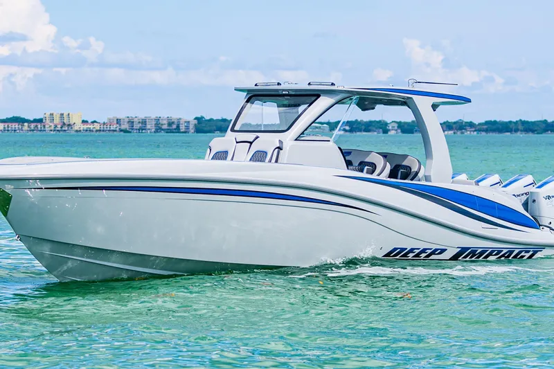  Yacht Photos Pics 2023 Deep Impact 399 Sport boat cruising on clear turquoise water.