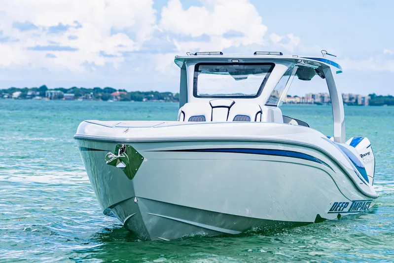  Yacht Photos Pics 2023 Deep Impact 399 Sport boat on clear blue water, showcasing sleek design.