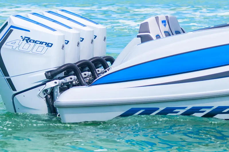  Yacht Photos Pics 2023 Deep Impact 399 Sport boat with powerful Racing 400 engines on clear water.