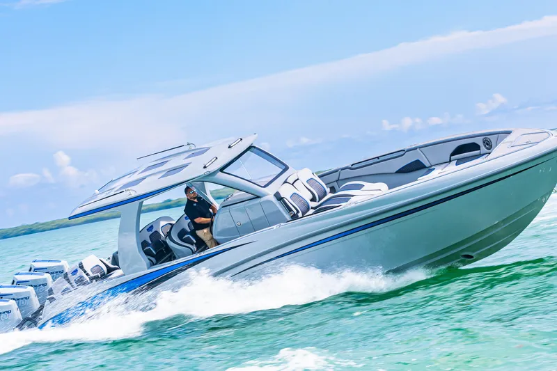  Yacht Photos Pics 2023 Deep Impact 399 Sport boat cruising on clear blue water.