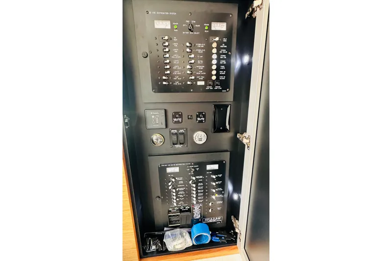 To The Moon And Back Yacht Photos Pics Electrical panel inside 2014 Cruisers Yachts 45 Cantius, showcasing switches and controls.