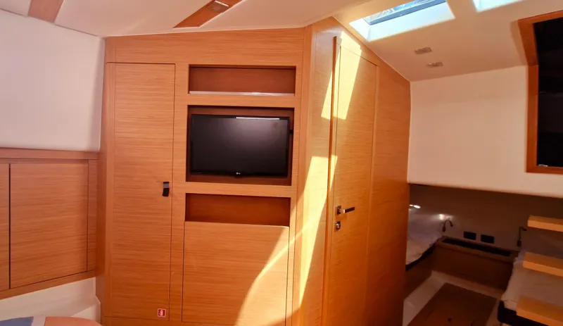  Yacht Photos Pics Interior of 2020 Pardo Yachts 43, featuring wood paneling and a mounted TV.