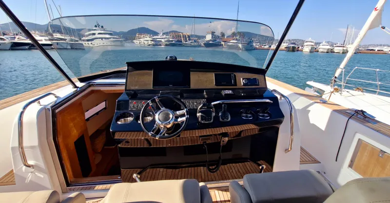  Yacht Photos Pics Helm of 2020 Pardo Yachts 43 with modern controls, docked in a marina.