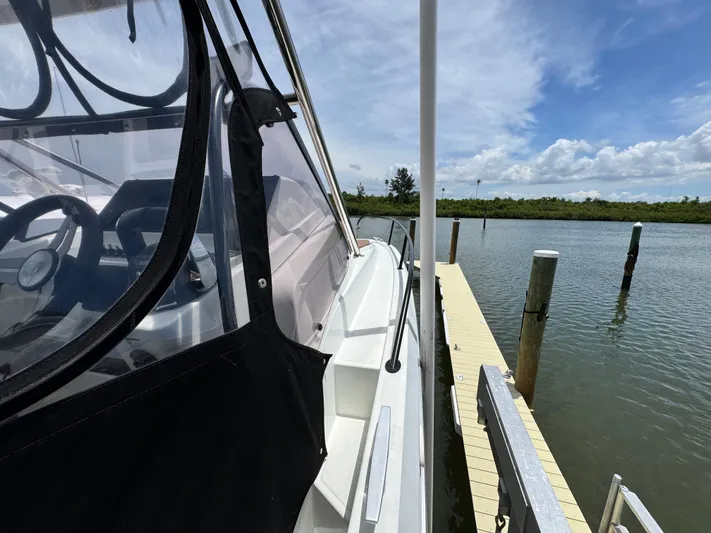  Yacht Photos Pics 2022 Beneteau Flyer 9 SUNdeck docked, showcasing sleek design and clear canopy.