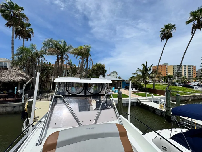  Yacht Photos Pics 2022 Beneteau Flyer 9 SUNdeck docked near palm trees and waterfront buildings.