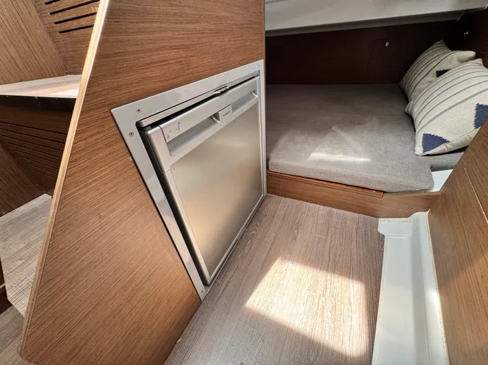  Yacht Photos Pics Interior of 2022 Beneteau Flyer 9 SUNdeck with compact fridge and cozy sleeping area.