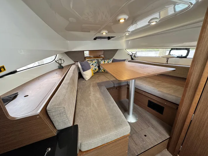  Yacht Photos Pics 2022 Beneteau Flyer 9 SUNdeck cabin interior with seating and table.