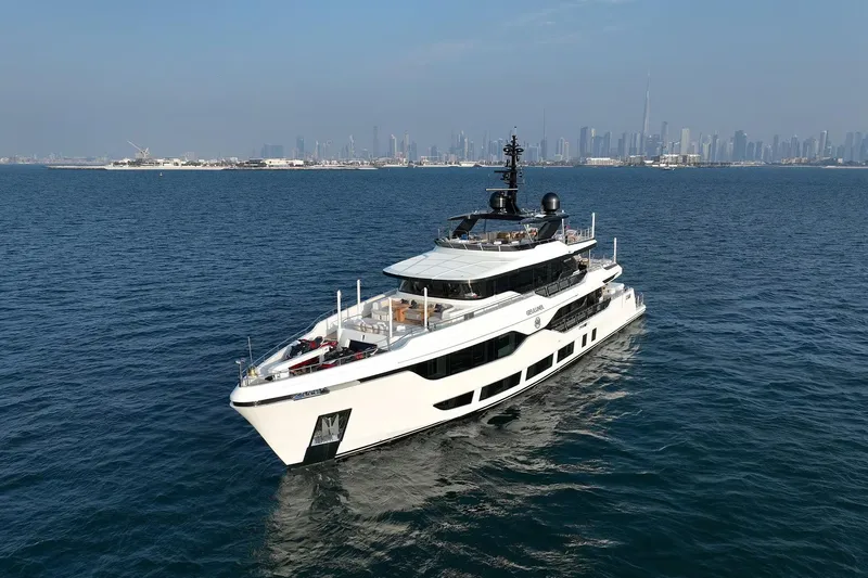 Geulunel Yacht Photos Pics Luxurious 2025 Majesty 120 yacht cruising in open waters with city skyline backdrop.