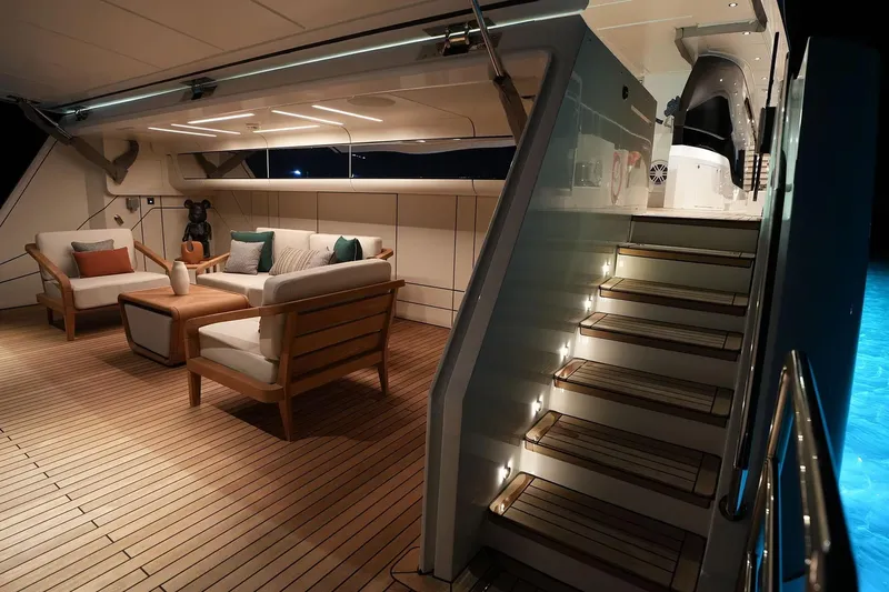 Geulunel Yacht Photos Pics Luxurious 2025 Majesty 120 yacht interior with elegant seating and illuminated staircase.
