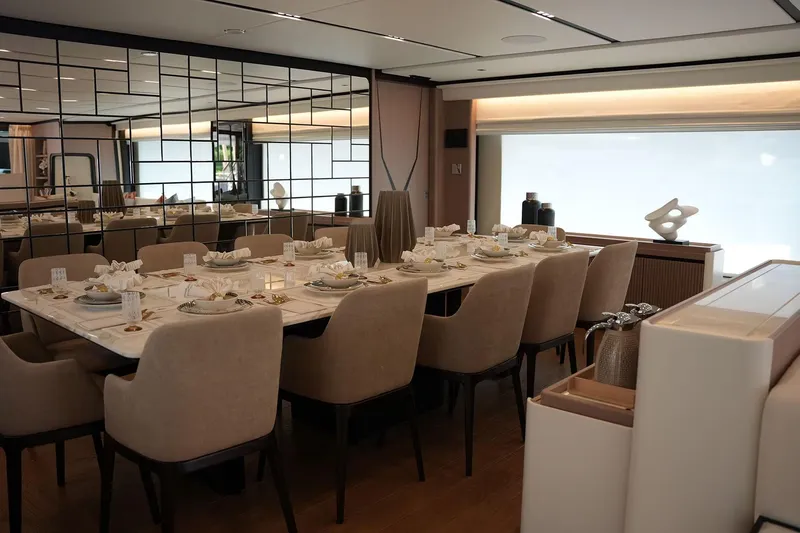 Geulunel Yacht Photos Pics Luxurious dining area on 2025 Majesty 120 yacht, featuring elegant table settings and modern decor.