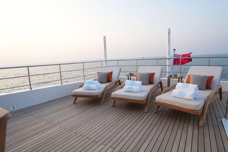 Geulunel Yacht Photos Pics Luxurious deck of 2025 Majesty 120 yacht with sun loungers and ocean view.