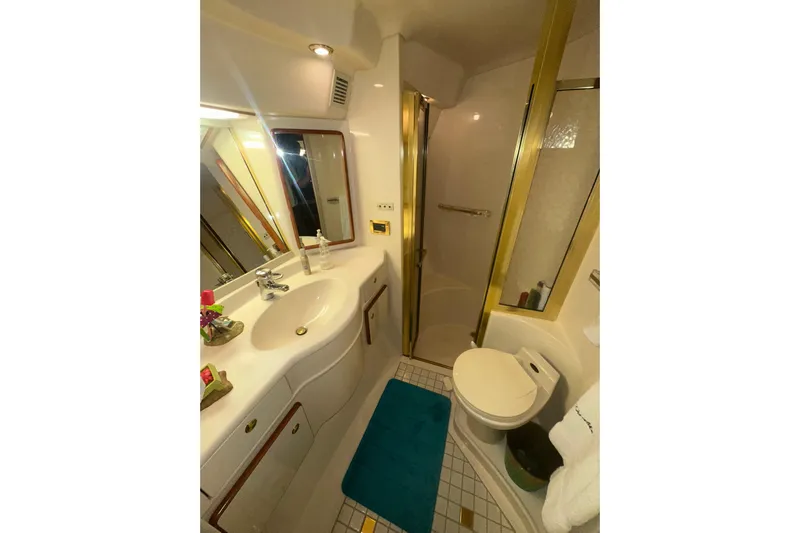  Yacht Photos Pics Bathroom interior of 1998 Sea Ray 500 Sundancer yacht, featuring shower, sink, and toilet.