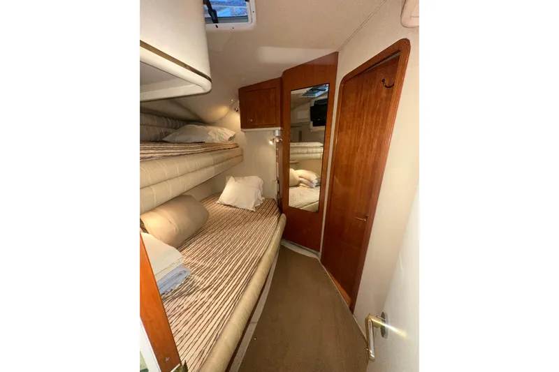  Yacht Photos Pics 1998 Sea Ray 500 Sundancer cabin with bunk beds and wooden door.