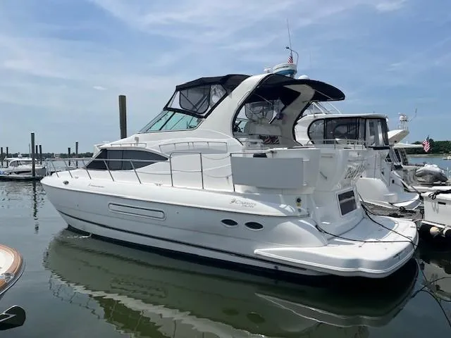  Yacht Photos Pics 2000 Cruisers Yachts 4450 Express Motoryacht docked in a marina.