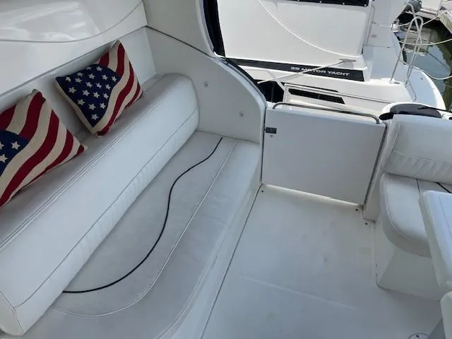  Yacht Photos Pics Luxurious 2000 Cruisers Yachts 4450 Express Motoryacht interior with white seating and decorative pillows.