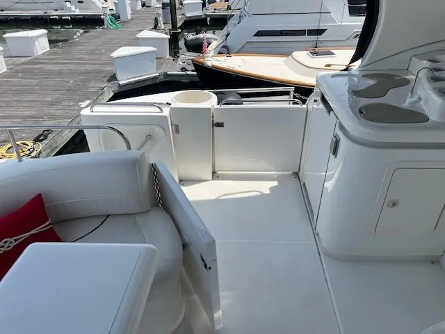  Yacht Photos Pics 2000 Cruisers Yachts 4450 Express Motoryacht interior with seating and kitchenette at dock.